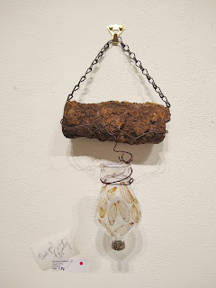 Assemblage made from rusty pipe, wire, old glass bottle, cicada wings