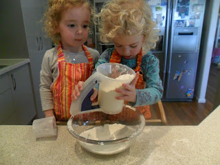 Sifting flour into a bowl for rainbow cake.