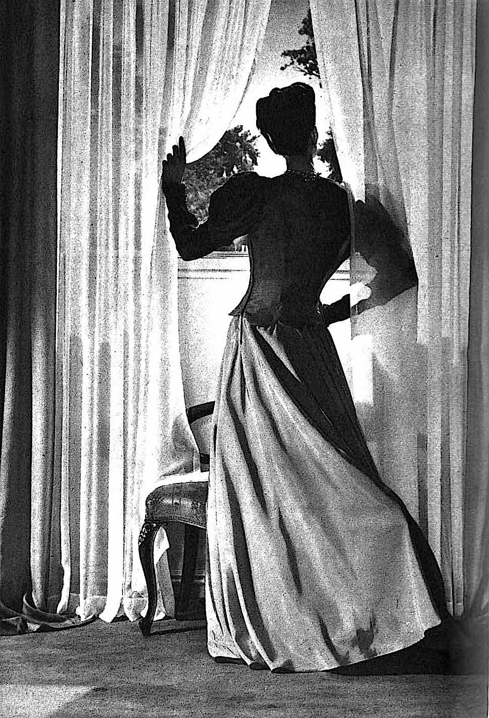 a 1941 noir photograph of a woman at a window