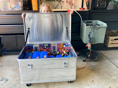 Assembled battery case, on wheels, charging at up to 30A with a "super charger" that I'll write up separately. Could of course hook up a solar charge controller as well.