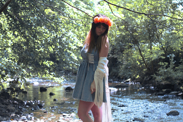 hippy girl, festival look, wearing roses and clementines floral crown in vivid orange, tassel kaftan kimono, denim pinafore topshop dress with tribal bone native american necklace with platform jeffrey campbell boots, British fashion, UK styling in the summer, how to get the hippy festival look.