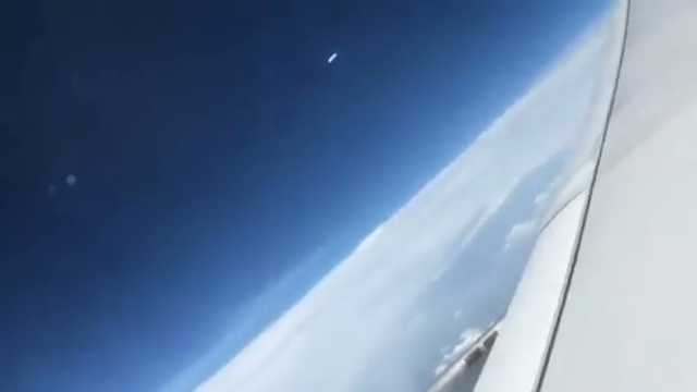 White Flying Saucer UFO caught on camera from a plane.