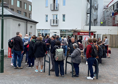 line of people waiting at Baejarins Beztu Pylsur hot dog stand in Reykjavik, Iceland