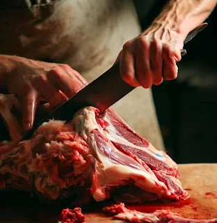 Butcher cutting sheep meat