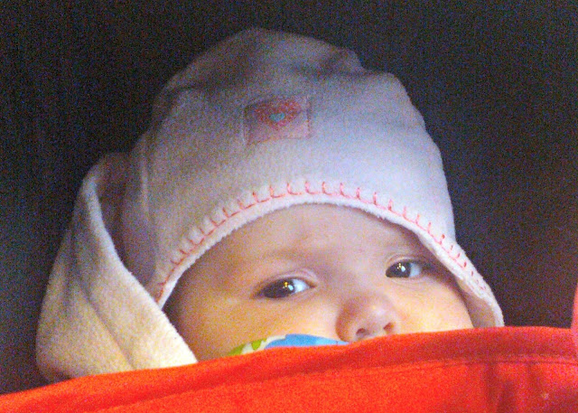 Baby girl wrapped up warmly peeking