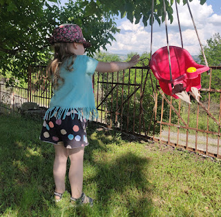 Rosie pushes Puppy in the swing