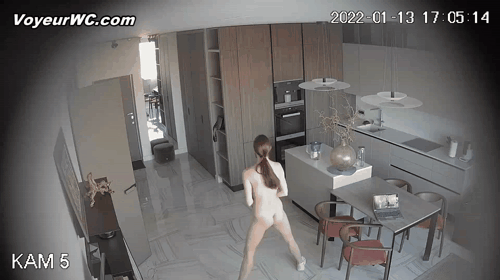A young woman is engaged in online workouts at home (Hacked Home Security Cameras 15-16)