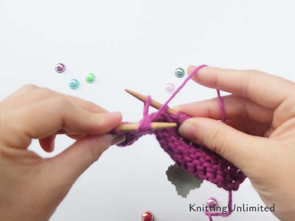 Pull the yarn through three stitches.