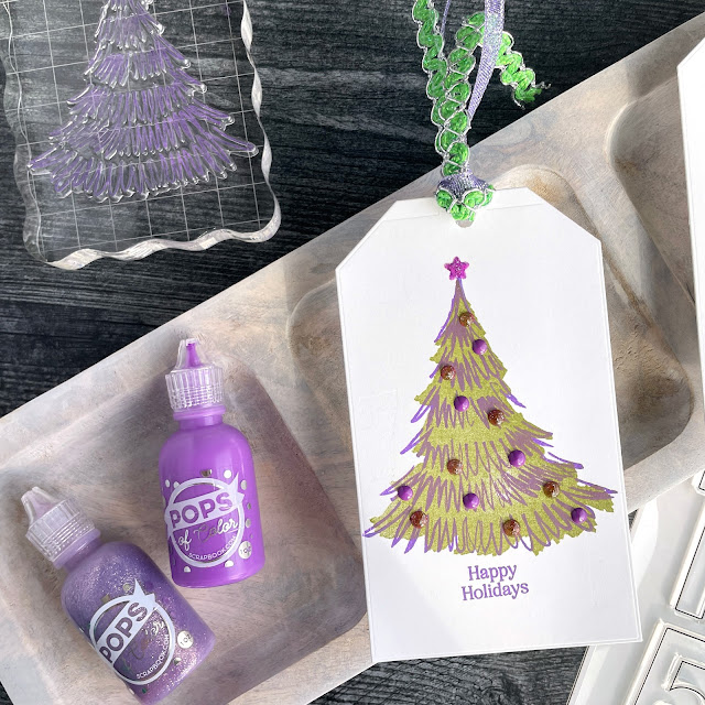 Bright Christmas tags made with: Scrapbook.com nested tags, bold numbers large stamp, christmas trees stamp, winter wishes and spruce sprigs stamp, pops of color in deep orchid lavender luster and pixie; Tim Holtz distress ink peeled paint, distress oxide wilted violet