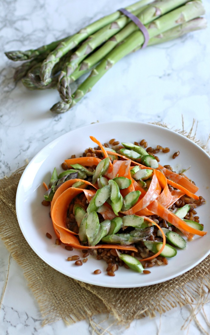 Recipe for a salad made with flax, asparagus and carrots topped with a tahini vinaigrette.