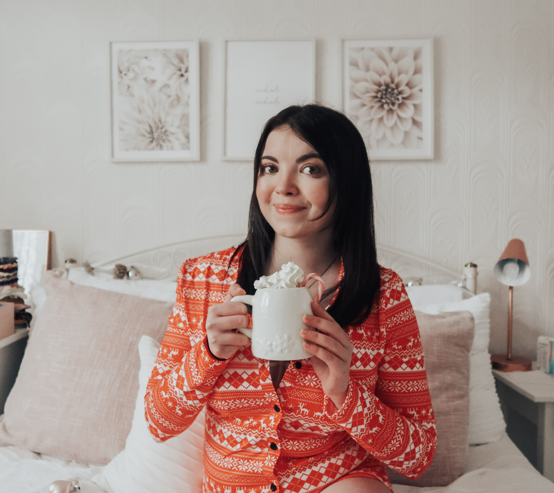 A woman holding a Christmas mug.