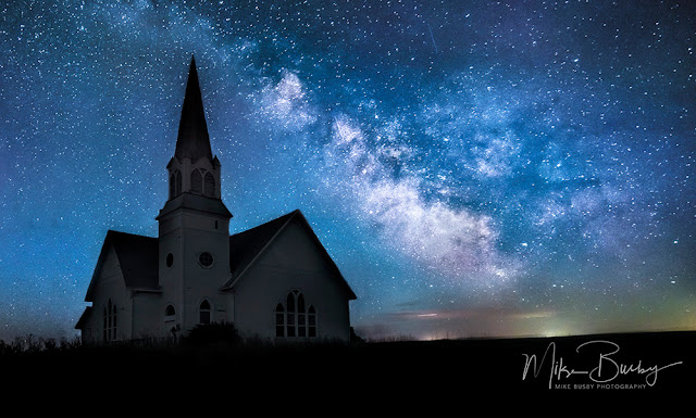 A photograph of a church framed with the Milky Way