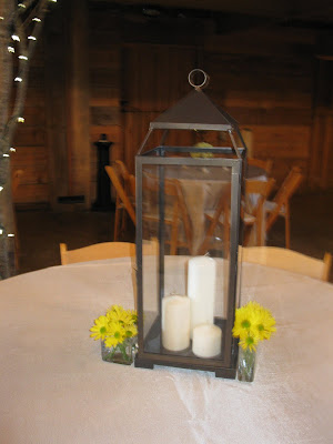 The centerpieces alternated heights of metal lanterns and vases filled with