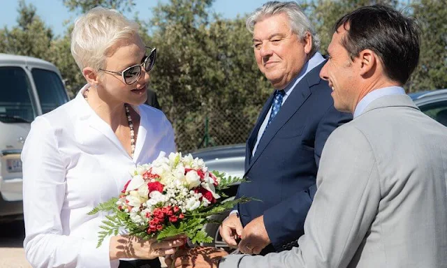 Princess Charlene wore a white stand collar poplin blouse by Akris. La Societe Protectrice des Animaux (SPA) of Monaco. Prince Albert