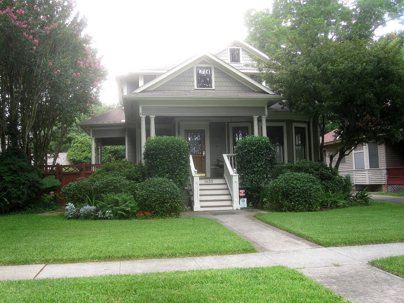 The classic look with trimmed hedges and a variety of other plantings 