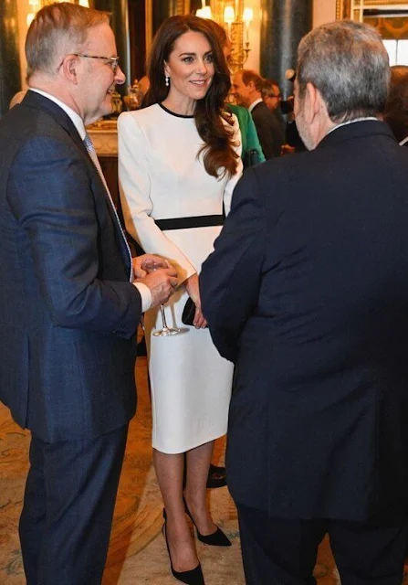 The Princess wore a white dress by Jenny Packham, Aquazzura slingback pumps, The Duchess wore a grecian dress by Suzannah