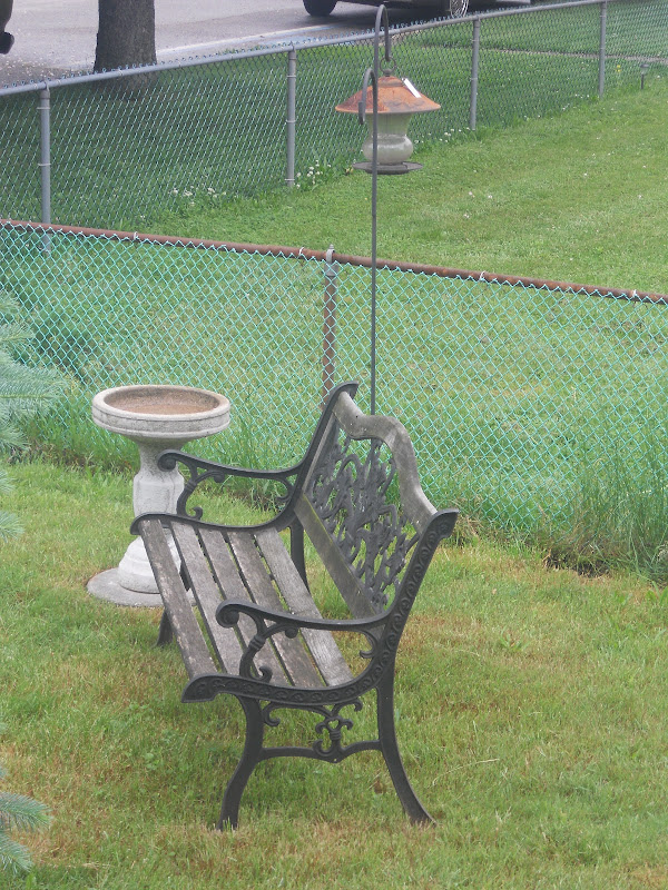 My simple little sitting area, bench, bird bath and bird feeder. title=