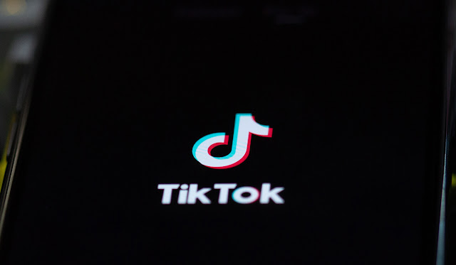 Close up of phone with the TikTok logo displayed.