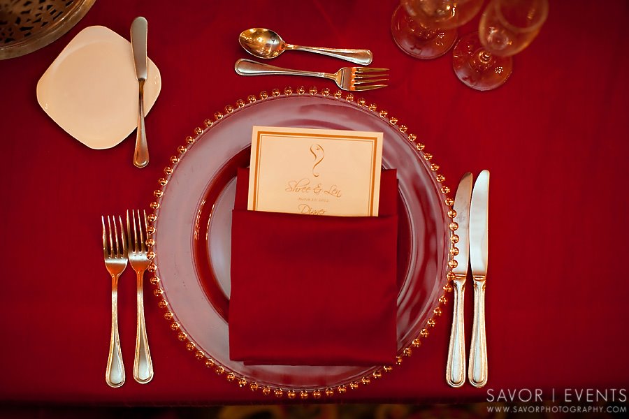 A two tone wedding theme of gold and red alternating tables
