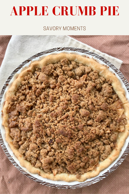 Finished baked apple crumb pie in a pie plate.