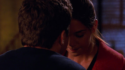 Pacey leaning in for a kiss while Joey pulls back, rejecting him