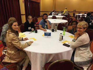 people gathered around a table, smiling