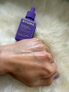 Byoma Hydrating Recovery Oil fully rubbed into hand, revealing soft, radiant skin with a hydrated, dewy finish