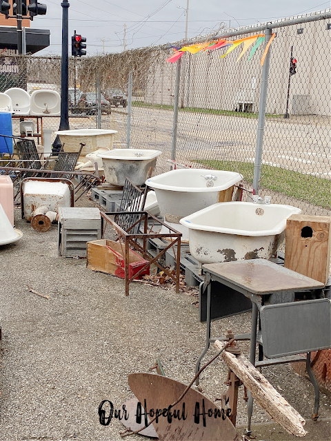 parking lot filled with vintage clawfoot tubs and sinks