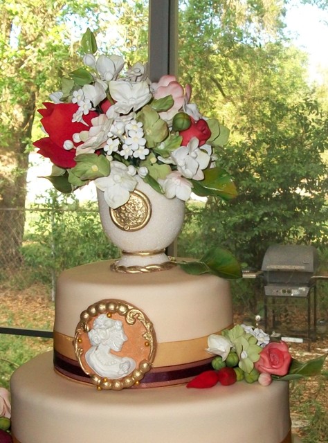  wedding cake with a sugar vase on top filled with more gorgeous flowers