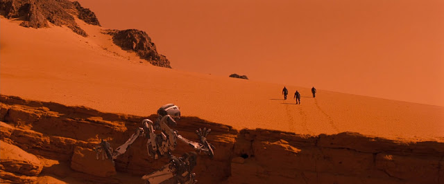 Robot Amme watching astronauts from Red Planet movie