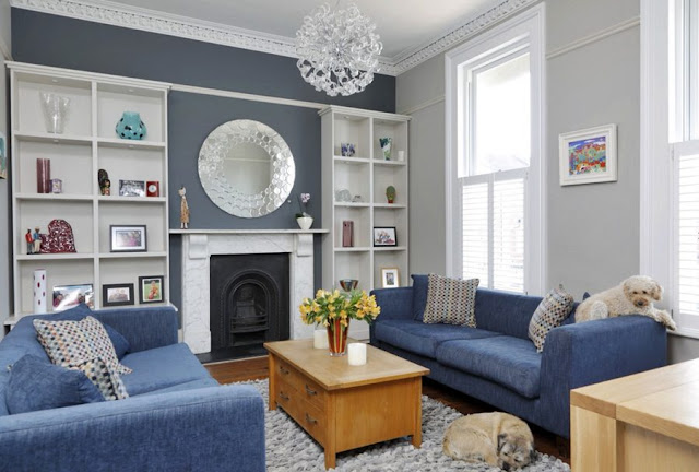 living room with blue sofa