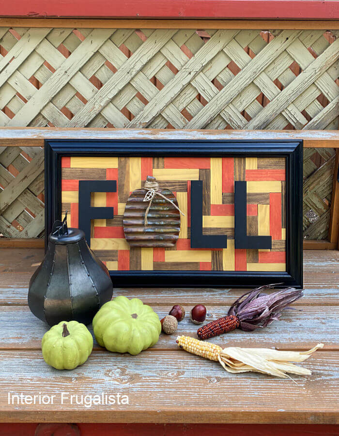 An easy beginner recycled wood tile geometric mosaic fall wall art with a simple pattern that doesn't require intricate cuts, stained in fall colors.