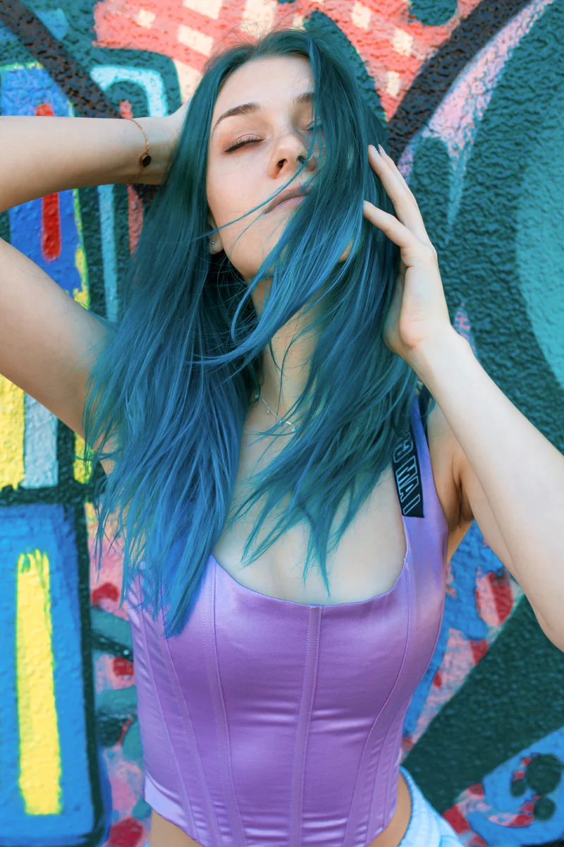 portrait of a beautiful woman with a bright blue wig