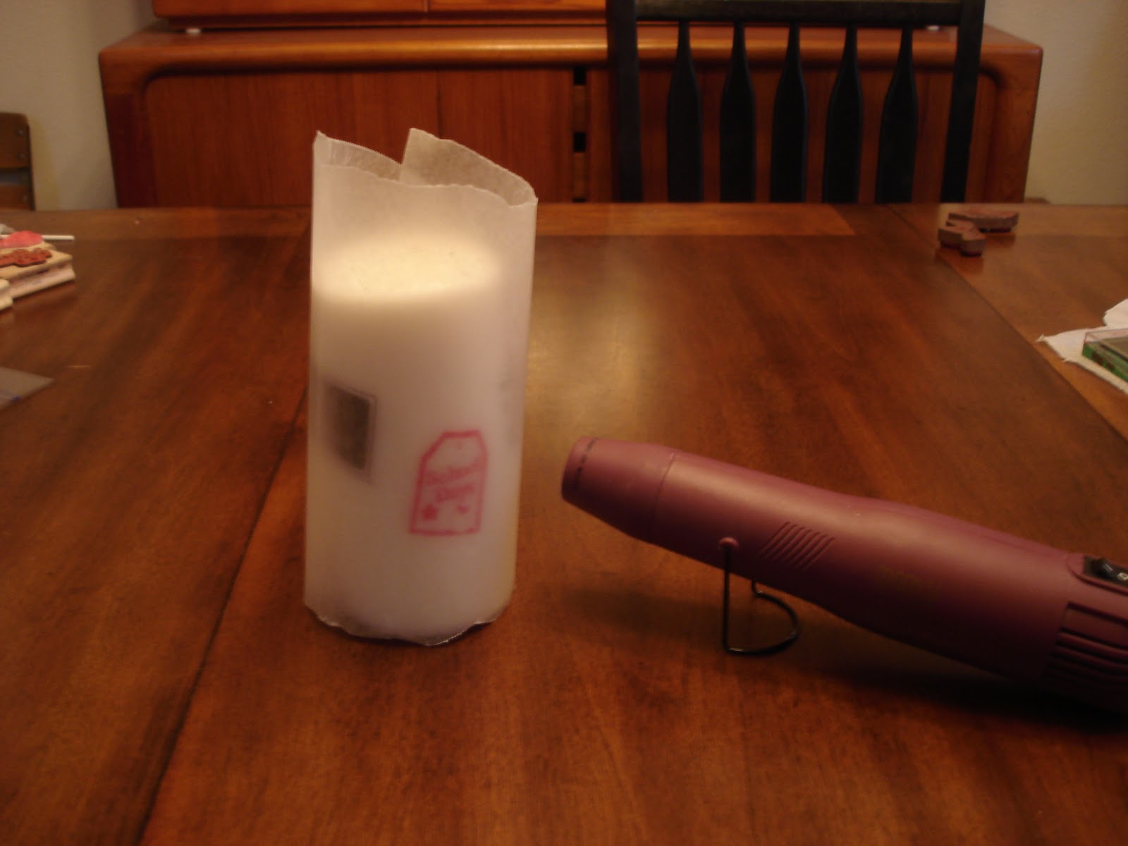 Next, wrap the wax paper around the candle and hold it firmly in place