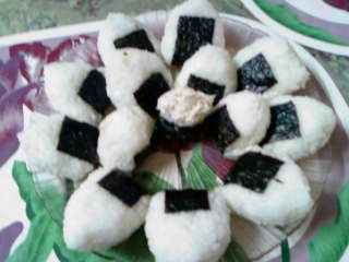 My own home made onigiri! On a flowery background. With a... hmm... sushi??? O_o