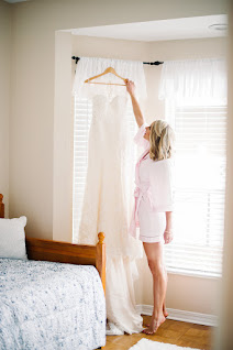 bride reaching for her wedding gown