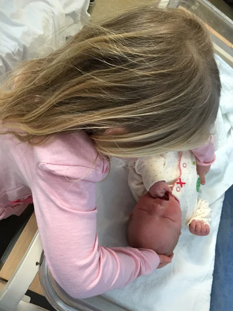 M the big sister meeting her new born sister for the first time