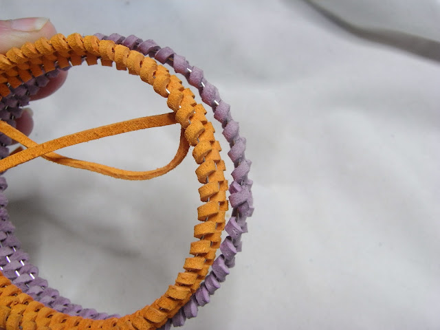 The diameter of the woven orange bangle is now smaller than the purple one.