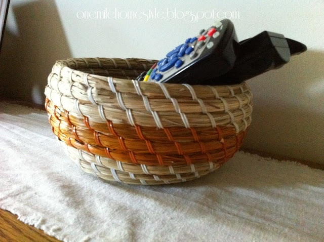 Round basket with orange stripe to hold remote controls