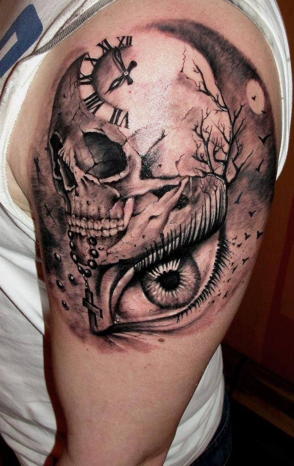 Clock with skull and eye tattoo on shoulder