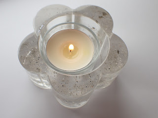 Clear resin flower shaped candle holder containing ashes