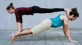 couple doing balancing yoga