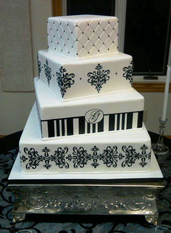 Lovely four tier black and white damask wedding cake with green satin ribbon 