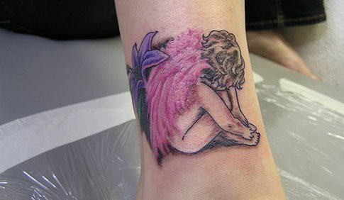 Praying baby angel tattoo. Baby angel with flower 