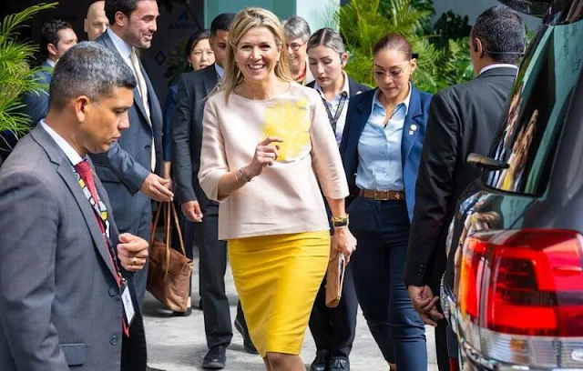 Queen Maxima wore a beige silk satin top by Natan, and a yellow satin skirt by Natan. Spring Summer 2018 collection