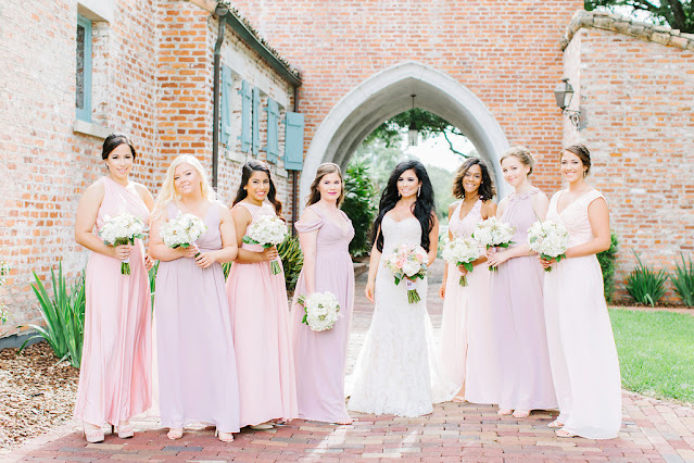 bride and bridesmaids in shades of pink dresses