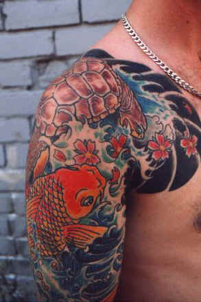 Japanese Koi Fish Arm Tattoo. This light coloured full upper arm tattoo is