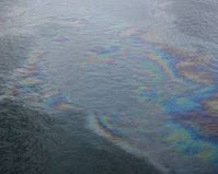 An oil slick spreading over the surface of the sea, polluting the marine environment and harming marine life.