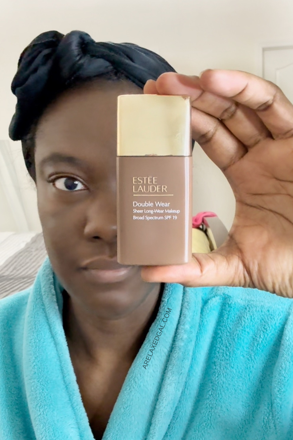 black woman holding foundation alternative estee lauder sheer foundation