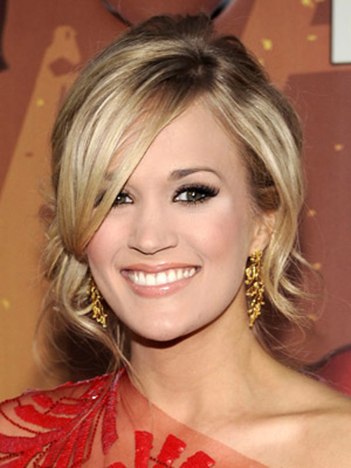 Carrie Underwood adds a twist to her side bun with loose, face-framing pieces.